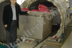 Man posing with a High Vacuum Biomedical waste Autoclave